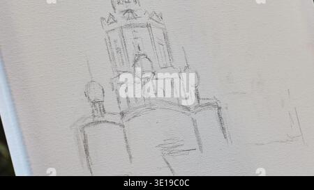 Artist drawing urban landscape on canvas with pencil Stock Photo
