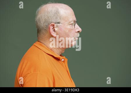 Profile view of grey haired senior man with mustache wearing eyeglasses horizontal shot Stock Photo