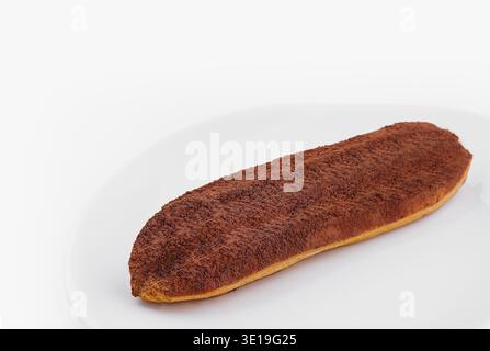 Delicious homemade eclairs with a chocolate powder on a white background Stock Photo
