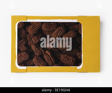 Top view of an open box filled with rich chocolate cookies isolated on white Stock Photo