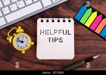 High angle view of Helpful tips text on notepad Stock Photo