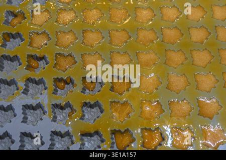 Oakville, ON, Canada - March 11, 2026: The image shows the process of making maple syrup candies in a maple leaf-shaped mold. Stock Photo