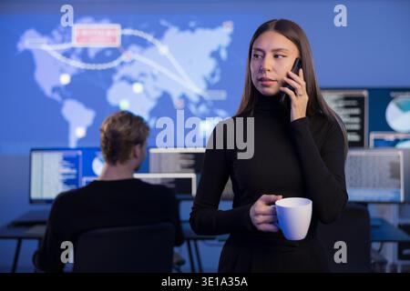 Cybersecurity analysts working in a SOC monitoring threats and incidents Stock Photo