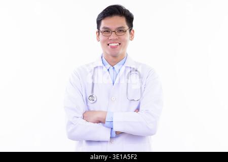 Studio shot of young handsome Asian man doctor with eyeglasses isolated against white background Stock Photo