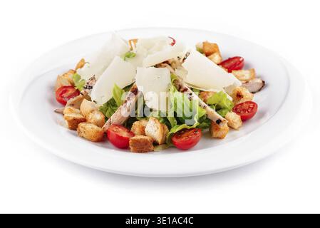 Freshly made caesar salad with parmesan cheese and grilled chicken on white plate Stock Photo