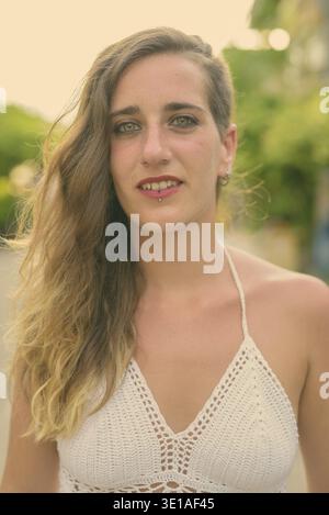 Portrait of young beautiful Hispanic tourist woman in the streets outdoors Stock Photo