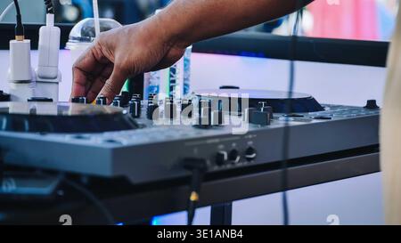 DJ mixing music at India Day festival in Moscow, hand on professional audio mixer Stock Photo