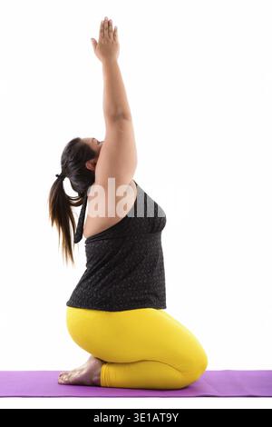 Studio shot of young fat Asian woman sitting while doing yoga poses Stock Photo