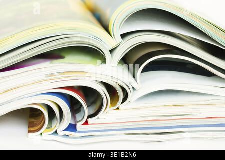 Pile of many open glossy paper magazines Stock Photo