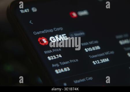 GameStop Corp's stock at $23.74 in a digital stock app using a dark interface Stock Photo