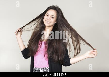 Studio shot of young beautiful multi ethnic woman against white background Stock Photo