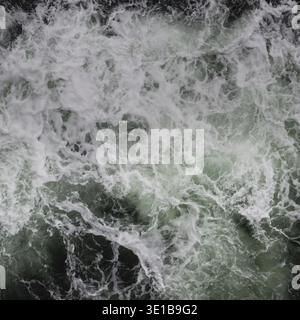 Big water splash seen from above a boat Stock Photo