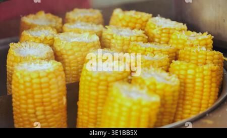 Many yellow corn on the cob pieces cooking at India Day festival in Moscow Stock Photo