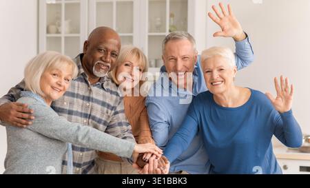 Group of Friends Enjoying a Moment Together at Home Smiling and Waving Stock Photo