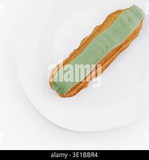 Overhead view of a delicious eclair with green icing on a clean white plate, isolated on a white background Stock Photo