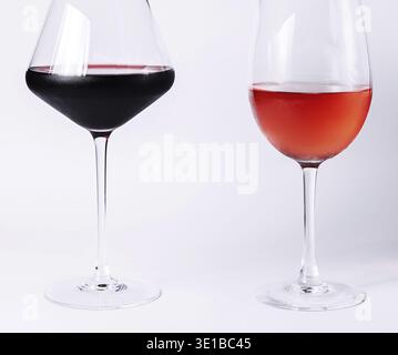 Two glasses are filled with red and rose wine, showcasing the color variations Stock Photo