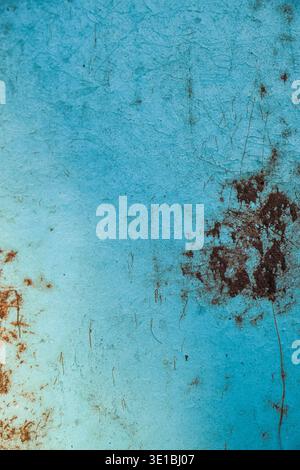Close up of a rough blue painted surface with weathered rust stains, dirt spots and fine scratches, abstract grunge texture with copy space  Stock Photo