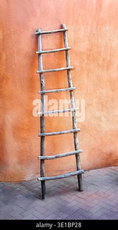 Old wooden ladder leans against the wall of an adobe building in "Old Town" in Albuquerque, New Mexico. Stock Photo