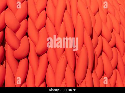 Abstract orange braided fabric creating a vibrant pattern and soft textile background Stock Photo