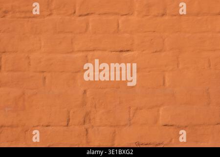 Orange painted brick wall texture with rough surface for backgrounds Stock Photo