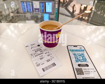 Paper cup with espresso, receipt, QR code for a rewards program or digital ordering, Moon Thai Express cafe, Hong Kong airport, Asia Stock Photo