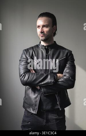 Confident bearded man wearing black leather jacket Stock Photo