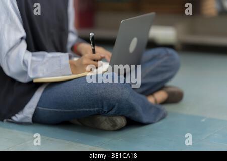 Young Asian Student Learning Online on Laptop at University Stock Photo