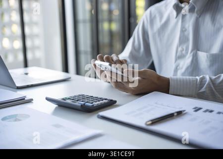 Successful Businessman Using Smartphone During Office Work Stock Photo