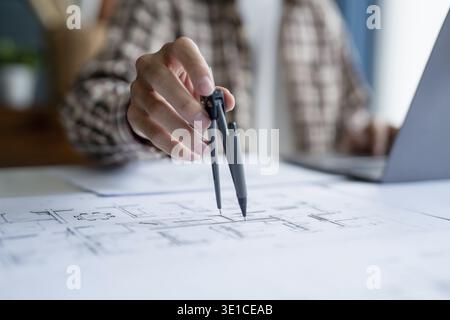 Architectural Drawing of Building Project with Colleagues Designing Blueprint Using Compasses Stock Photo