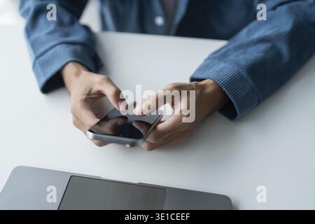 Man Using Smartphone in Modern Office Technology Stock Photo