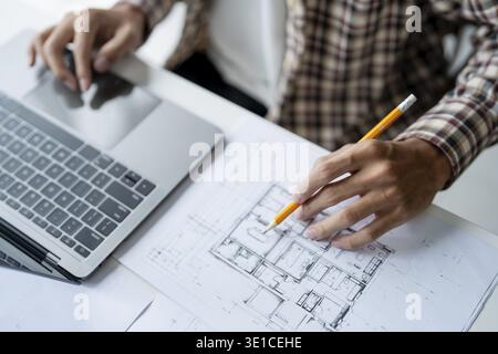 Architectural Drawing of Building Project with Colleagues Designing Blueprint Using Compasses Stock Photo