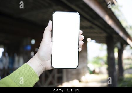 Smart phone mockup. Women hands holding cell telephone blank copy space screen smartphone blank white screen isolated technology Stock Photo