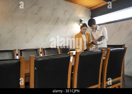 Asian Office Workers Collaborating in a Business Meeting Stock Photo