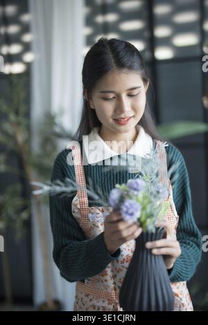 Happy asian female florist Startup small business successful SME in flowers shop Stock Photo