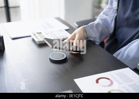 Woman charging smartphone by using magnetic wireless charger Stock Photo