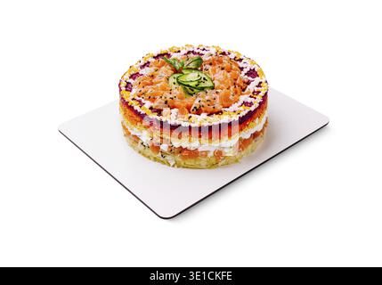 A vibrant layered cake made with salmon and vegetables sits on a white plate. The cake showcases a rainbow of colors, attracting attention with its fr Stock Photo