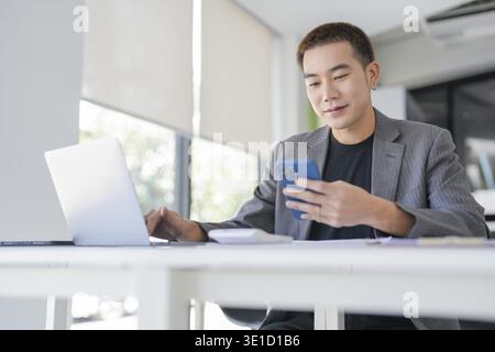 Asian Business man working with laptop. Young business man thinking Concentrated at work Stock Photo