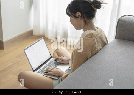Woman working by using a laptop computer Hands typing on keyboard. writing a blog. Working at home are in hand finger typewriter Stock Photo