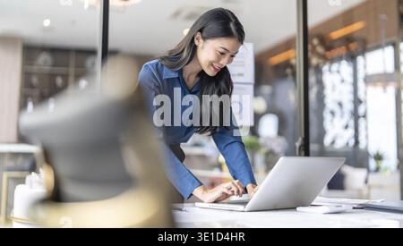 Beautiful Business Woman working by using laptop computer Hands typing on keyboard. Professional investor working new start up project. business plann Stock Photo