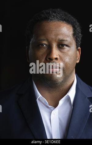 Portrait of handsome African man against black background Stock Photo