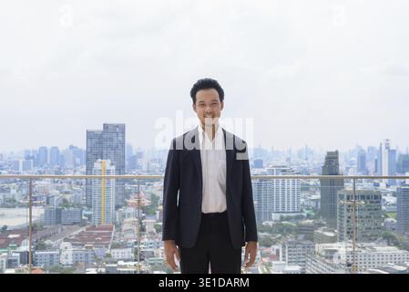 Portrait of man Asian businessman wearing suit outdoors in Bangkok, Thailand Stock Photo