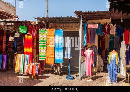 Colourful brightly coloured fabrics hanging on display outside a shop in the Souk des Teinturiers (Dyer’s Souk), Medina quarter in Marrakesh, Morocco Stock Photo