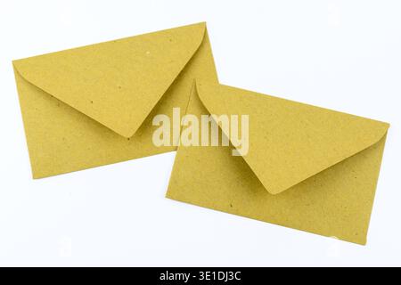Two kraft paper envelopes on a white background. Minimal concept for comparing options, messages, correspondence or alternative choices. Stock Photo