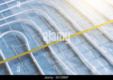 Underfloor heating pipes installation on construction site before concrete works Stock Photo