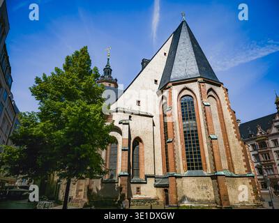 Nikolaikirche in Leipzig, Germany, Gothic church with tree and historic buildings in city center Stock Photo