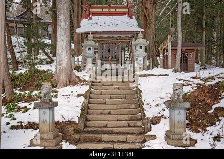 Nagano Japan - January 2026: Snow‑Covered Steps Leading to Timber Shrine Building at Togakushi Stock Photo
