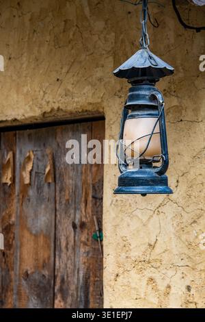 A traditional kerosene lantern hanging outside an old earthen house in Yaoshan Ancient Town, Guizhou Province, China. Stock Photo