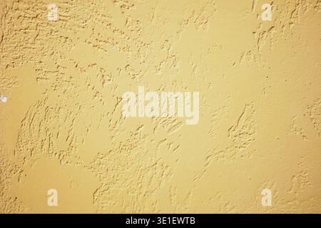Uneven yellow textured wall surface Stock Photo