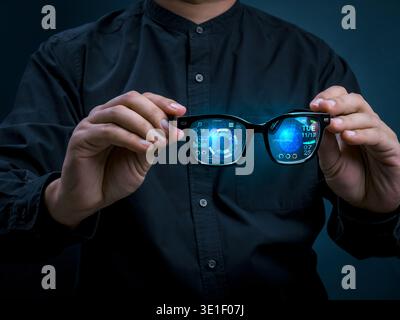Smart glasses with augmented reality interface displaying digital data and futuristic UI dashboard in businessman hands. Wearable technology, real-tim Stock Photo