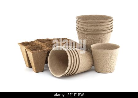 A collection of peat pots and seed starter trays made from recycled paper pulp, ideal for eco-friendly gardening practices Stock Photo